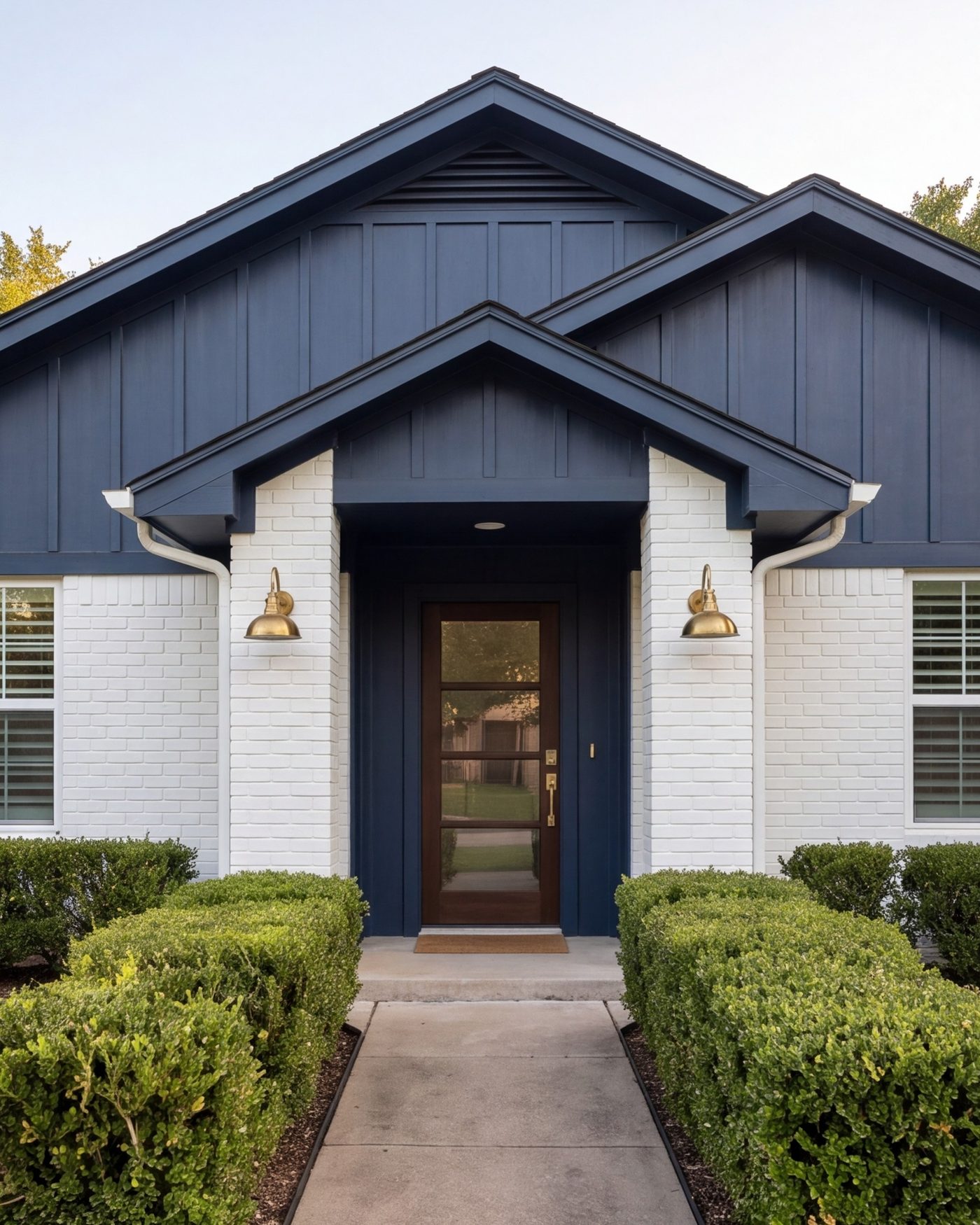 Front of a remodeled ranch house with new siding and a modern entry